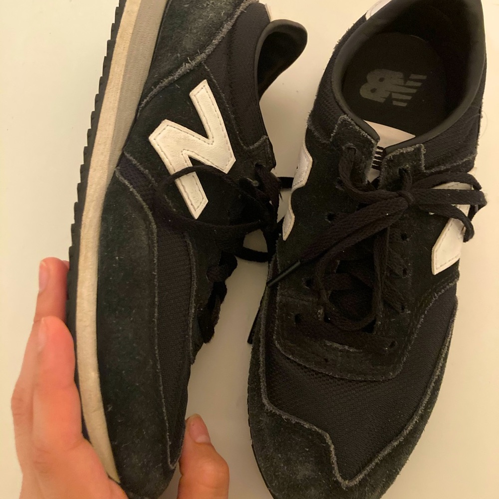 Black, white, and grey New Balances. Size 7.5